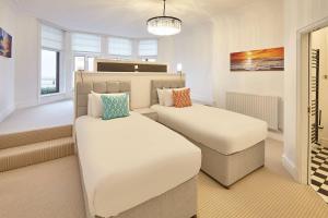 a bedroom with two beds and a window at Sea Forever Oceanfront Home Perfectly Saltburn in Saltburn-by-the-Sea