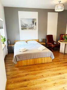 a bedroom with a bed and a table and a chair at Apartamenty Grodowa 2 in Gliwice