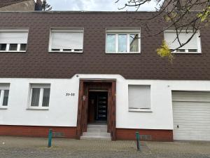 a white house with a brown roof at Apartment 2 in Duisburg-Mitte, Altstadt in Duisburg
