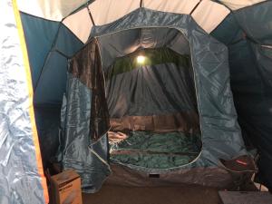 a person sleeping inside a tent at Tenda Photok Camping Reception in Funchal