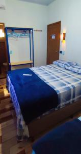 a bedroom with a blue and white bed in a room at HospedaAurora Casa 3 quartos in Manhã +10 photos