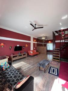 a large living room with a couch and a tv at Nandi Earth in Nandi