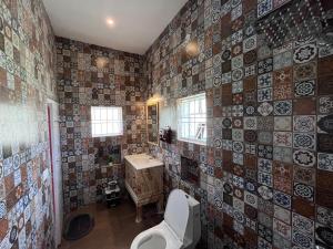 a bathroom with a toilet and a sink at Nandi Earth in Nandi