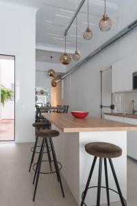a kitchen with a wooden counter and stools at Apartamento Barcelona centro in Barcelona