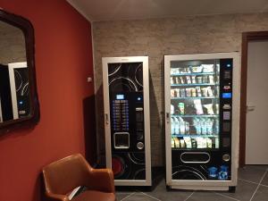 two vending machines are next to a wall at Guesthouse The Living Room in Grassobbio