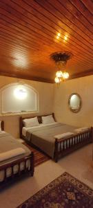 a bedroom with two beds and a wooden ceiling at Ktisis Butik Otel in Urfa