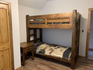 a bedroom with two bunk beds and a table at The Lake House - New Home on Lower Kaubinshine Lk in Minocqua