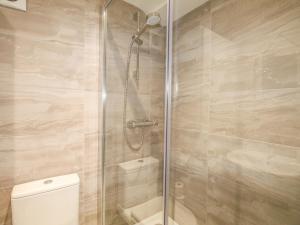 a shower with a glass door next to a toilet at Sunrise Apartment in Weymouth +28 photos