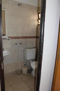 a bathroom with a toilet and a sink at Hotel Piamonte in Buenos Aires +6 photos