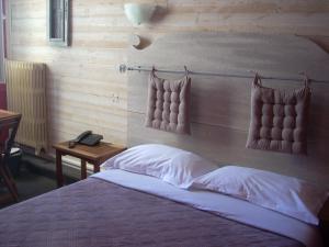 a bedroom with a bed and a phone on a table at Hotel du Château in Nantes