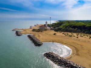 an aerial view of a beach with a lighthouse at LIDO dei PINI HOME in Bibione