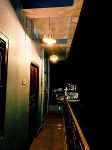 a dark room with a hallway with lights at Nikunj Dorme in Rājgīr