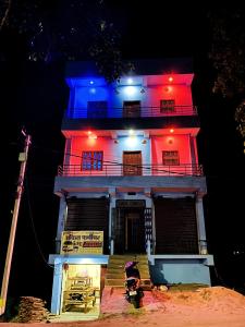 a building with a blue and red light on it at Nikunj Dorme in Rājgīr