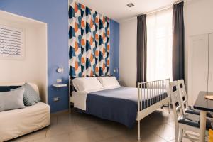 En eller flere senger på et rom på Neapolis Guest House