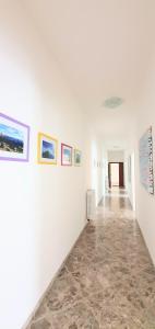an empty hallway with paintings on the walls at Angela's Apartment. Elegant two bedroom house in Irsina in Irsina
