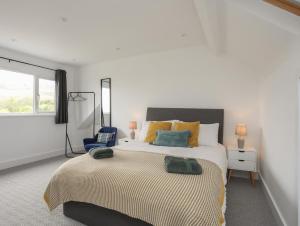 Un dormitorio con una cama grande y una ventana en Maes Y Ddol en Pwllheli
