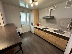 a kitchen with a sink and a counter top at Затишна квартира для Вашої родини in Vinnytsya