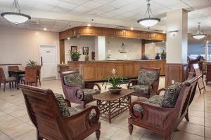 a lobby with chairs and a table and a bar at Royal Floridian Resort South by Spinnaker in Ormond Beach