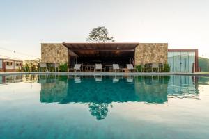 a large swimming pool with a building in the background at Santa Serra Itaipava in Itaipava