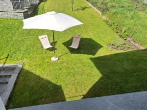 an overhead view of an umbrella and two chairs at Appartamento Ca' Battaglia in Chiesa in Valmalenco +22 photos