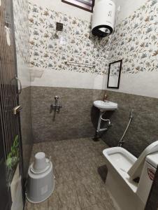 a bathroom with a sink and a toilet at Gratitude Retreat in Puducherry