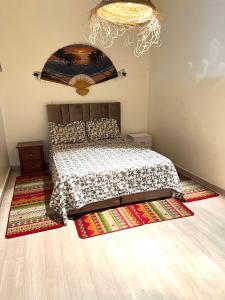 a bedroom with a bed and a rug on the floor at Cente ville House in Agadir