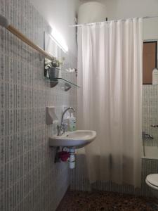 a bathroom with a sink and a shower curtain at Karystos central apartment, near the beach in Karistos