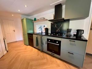 Η κουζίνα ή μικρή κουζίνα στο Kindvriendelijk sfeervol vakantiehuis Bosgeneugte bij zwembad op de Veluwe