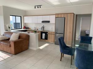 a living room with a couch and a glass table at Guthulele Living in Ballito