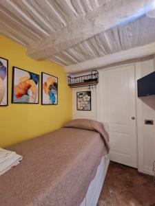 a bedroom with a bed and a yellow wall at LEONARDO Loft NAPLES in Naples