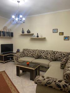 a living room with a couch and a tv at Armando's apartment in the center in Durrës