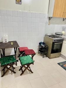 a kitchen with a table and chairs and a stove at Cente ville House in Agadir