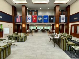 a lobby with chairs and flags on the wall at La Quinta by Wyndham Bannockburn-Deerfield in Bannockburn