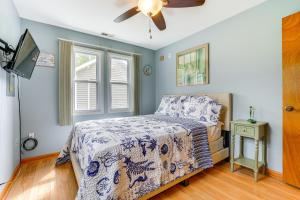 a bedroom with a bed and a ceiling fan at Kayak, Fish, Boat and Swim Home Near Lakeside Park! in Woodland Beach