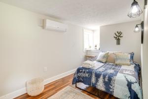 a bedroom with a bed with a blue comforter at Riverfront Shenandoah Getaway with Kayaks and Tubes! in Shenandoah