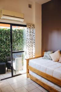 a bedroom with a bed and a window at Acacia in Mendoza