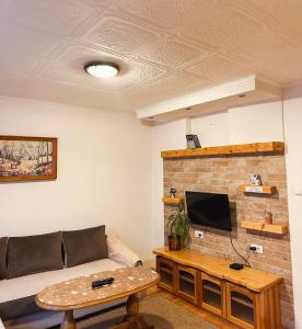 a living room with a couch and a tv at Apartman Olivera in Žabljak
