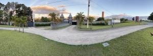 a curved road in a park with palm trees at Plaza Motel in Sorocaba