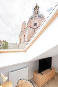 a living room with a tv and a building at GRAND CROWN in Vilnius