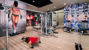 a man laying on the floor in a gym at El Dorado Seaside Suites Oceanfront, Catamarán, Ecoturistic Ranch, All & More Inclusive - Adults Only in Akumal +28 photos