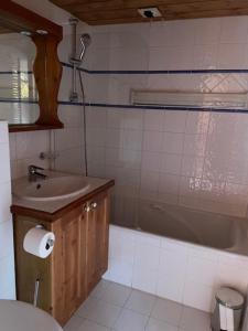 a bathroom with a sink and a tub and a toilet at Appartments in Tignes Ecrin des Neiges in Tignes