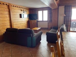 a living room with couches and a flat screen tv at Appartments in Tignes Ecrin des Neiges in Tignes