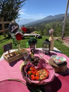 una mesa de picnic con una cesta de comida. en Sol y Luna Glamping, en Málaga