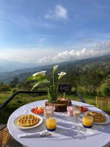 a table with waffles and orange juice on it at Sol y Luna Glamping in Málaga