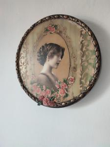 a plate with a picture of a woman with flowers at Ανατολή in Veria