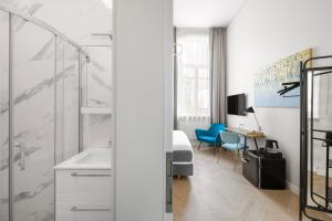 a bathroom with a sink and a desk in a room at GRAND CROWN in Vilnius