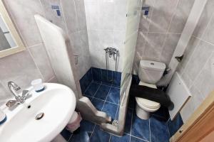 a small bathroom with a sink and a toilet at Olympio Luxury Studio Paros in Kampos Paros