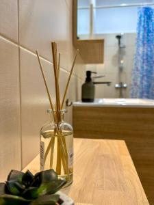 a vase filled with water on a table with a plant at Serenity House Apartments in Sibiu +12 photos