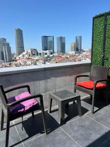 2 Stühle und ein Tisch auf einem Balkon mit Aussicht in der Unterkunft The Blue Suites in Istanbul