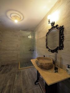 a bathroom with a sink and a mirror at Sophia Areopoli Guesthouse in Areopoli